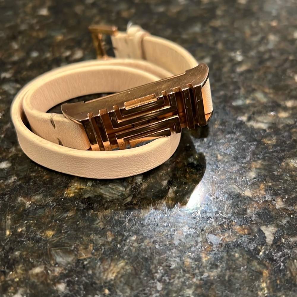 Tory Burch Fitbit bracelet case with gold case and leather wrap strap